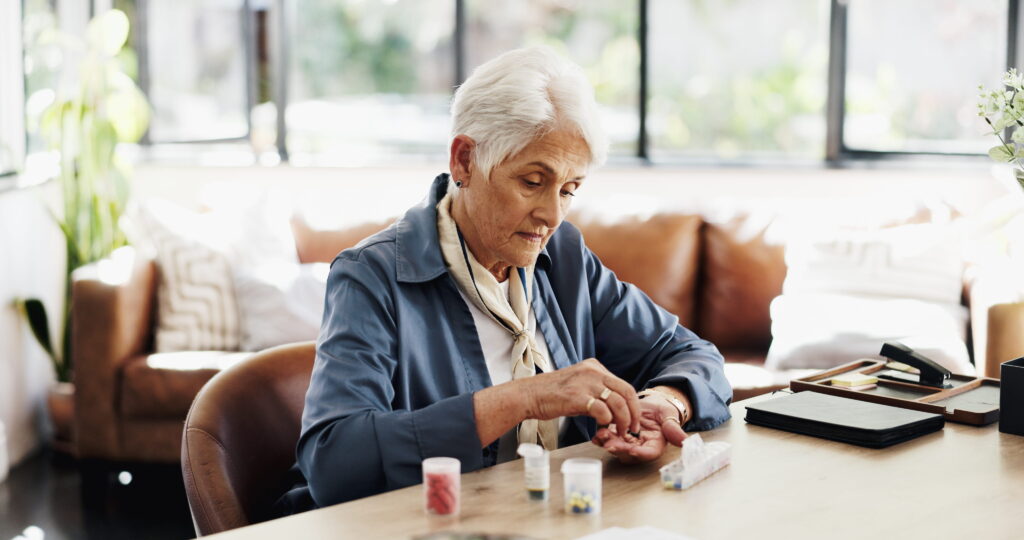 Elderly person organising her pills in a Pill Organisers